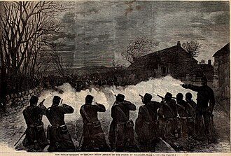 Engraving of a line of men firing rifles across open ground towards a farmhouse in the dark, printed caption below